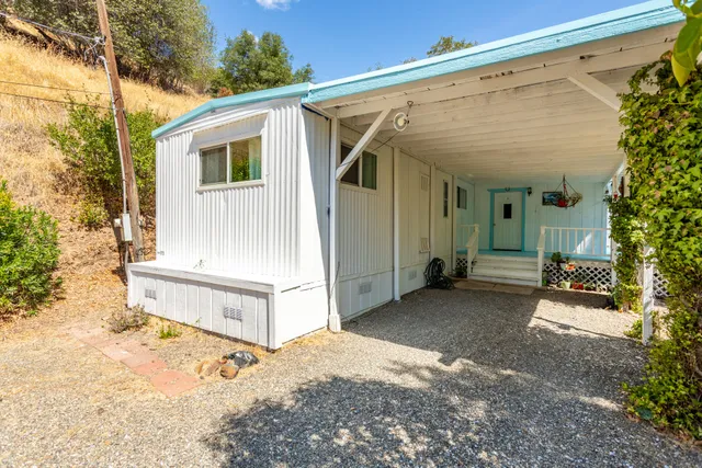 a view of a house with a yard and tree