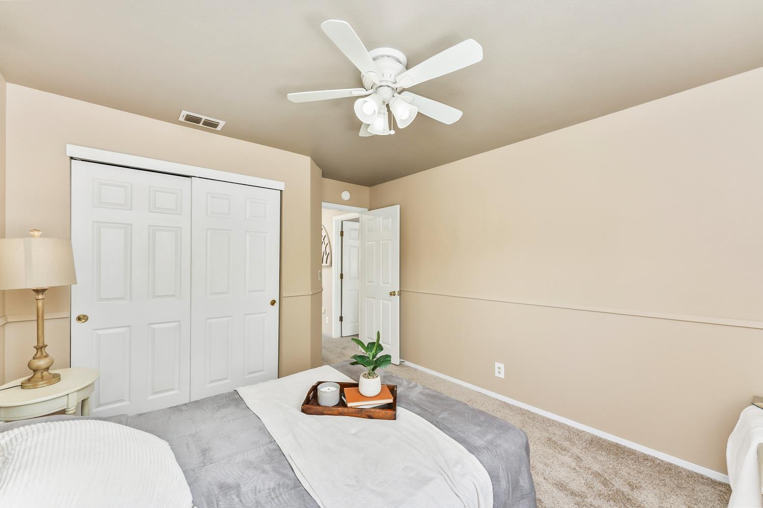 3472 See View Court Rescue, CA 95672 - Photo 24 of 37 a bedroom with a bed and a chandelier fan