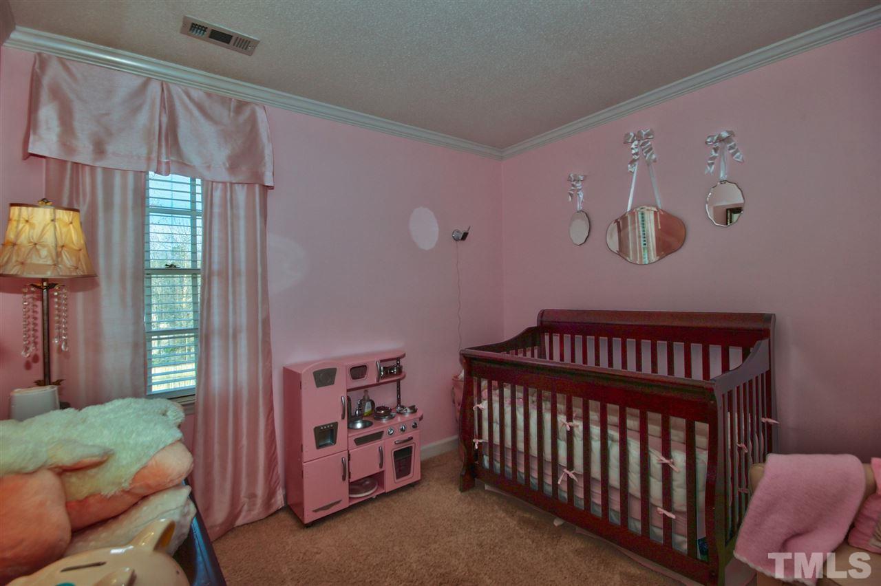 7141 Kinross Drive Raleigh, NC 27613 - Photo 13 of 19 a bedroom with furniture and a window