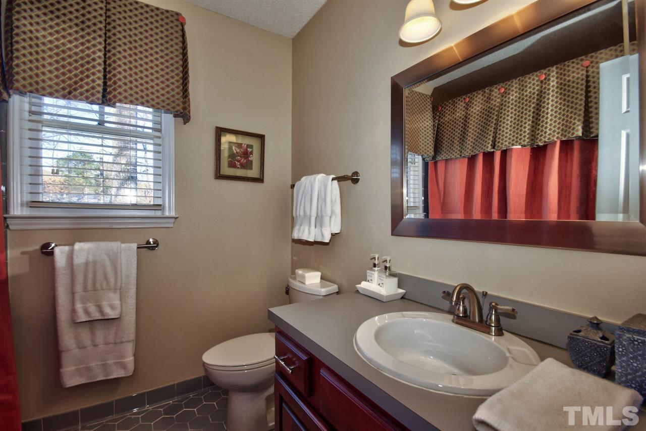 7141 Kinross Drive Raleigh, NC 27613 - Photo 15 of 19 a bathroom with a sink toilet and mirror