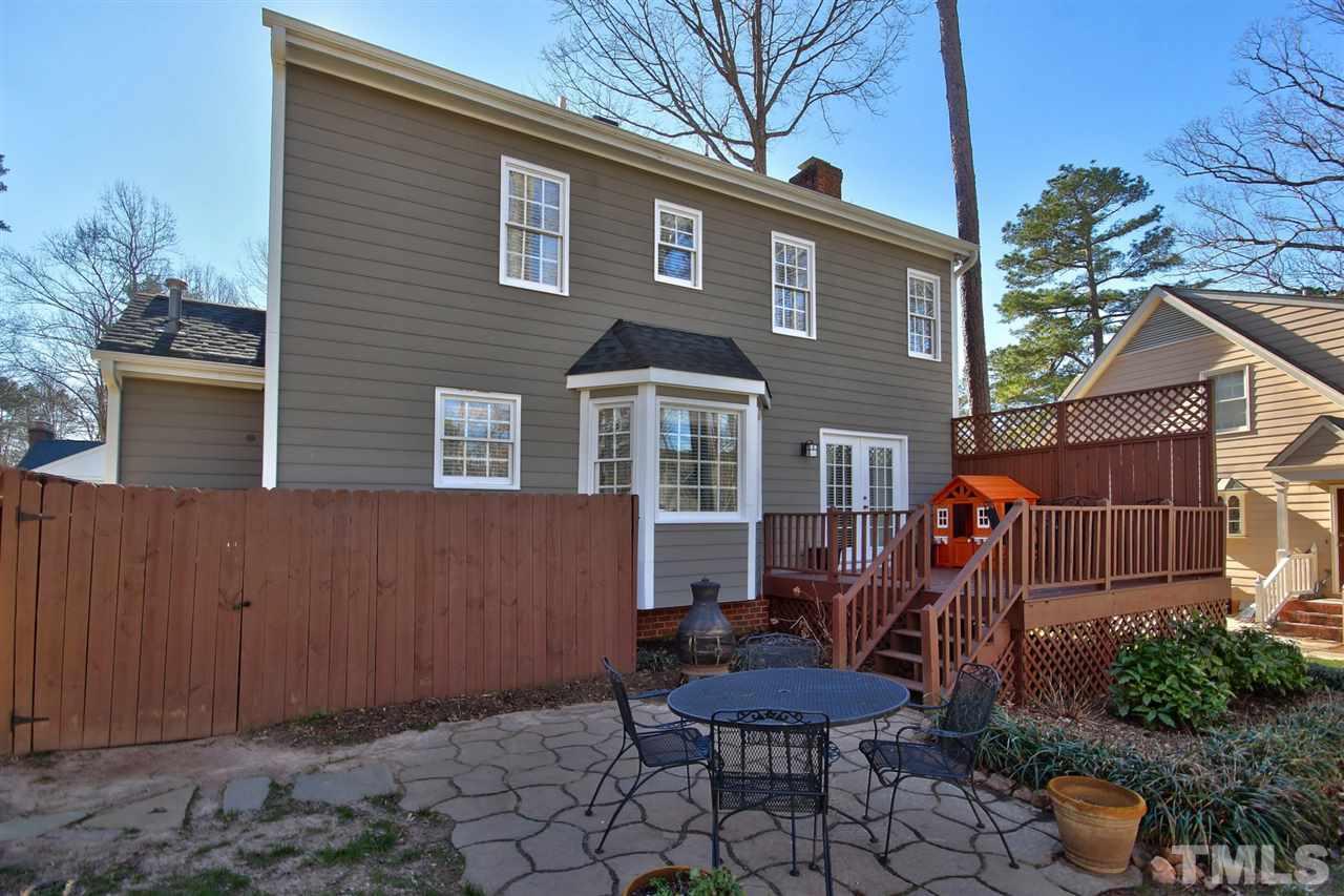 7141 Kinross Drive Raleigh, NC 27613 - Photo 17 of 19 a front view of a house with garden and chairs