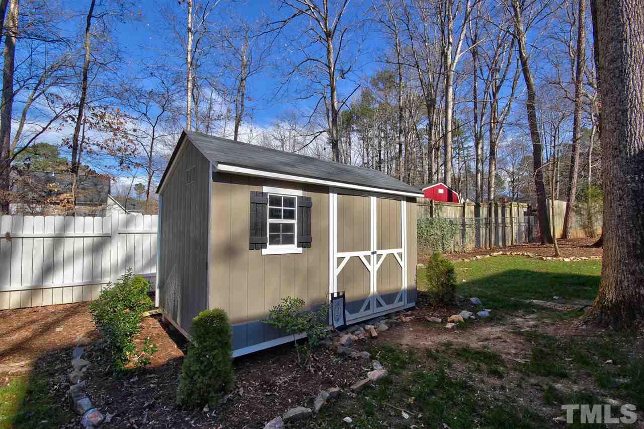 7141 Kinross Drive Raleigh, NC 27613 - Photo 19 of 19 a backyard of a house with lots of green space