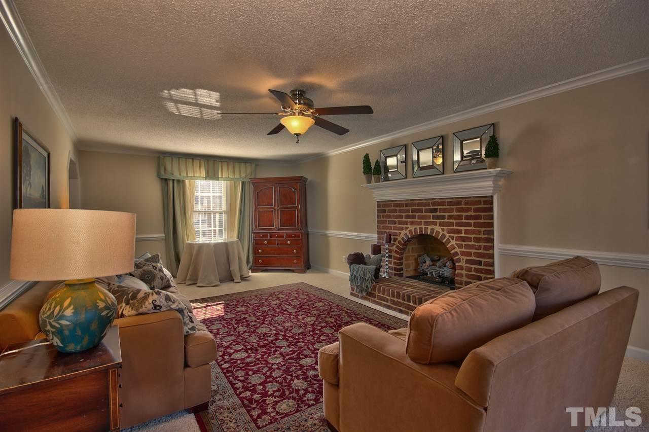 7141 Kinross Drive Raleigh, NC 27613 - Photo 3 of 19 a living room with furniture fireplace and window