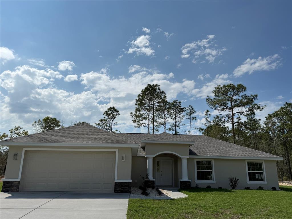 a front view of a house with garden