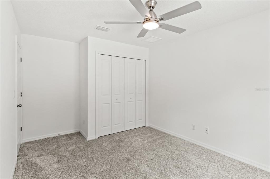 15333 Honeycreeper Road Brooksville, FL 34614 - Photo 16 of 19 an empty room with a fan & a ceiling fan