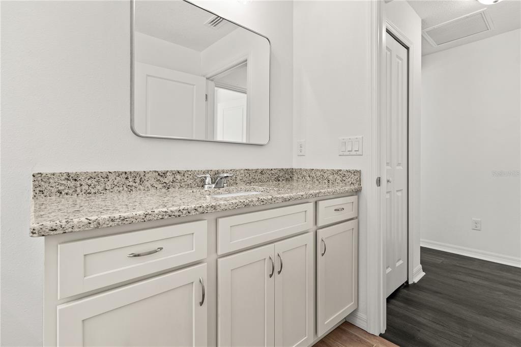 15333 Honeycreeper Road Brooksville, FL 34614 - Photo 18 of 19 a bathroom with a granite countertop double vanity sink and mirror
