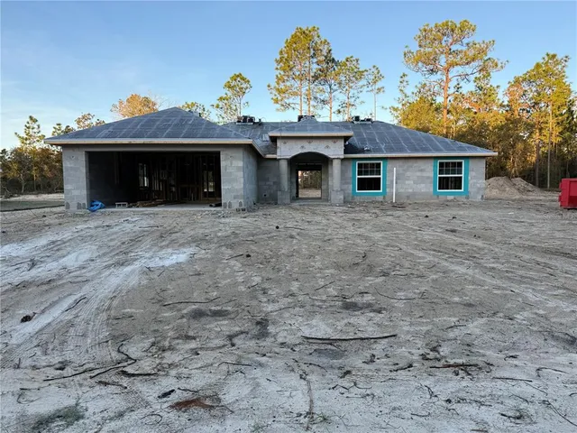a view of a house with a yard and a garage