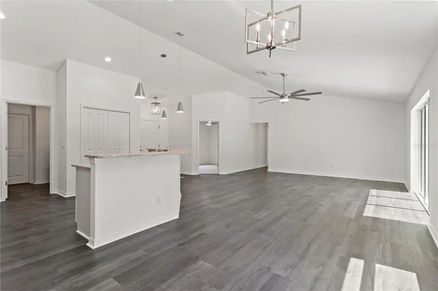 a view of a kitchen with wooden floor and a ceiling fan