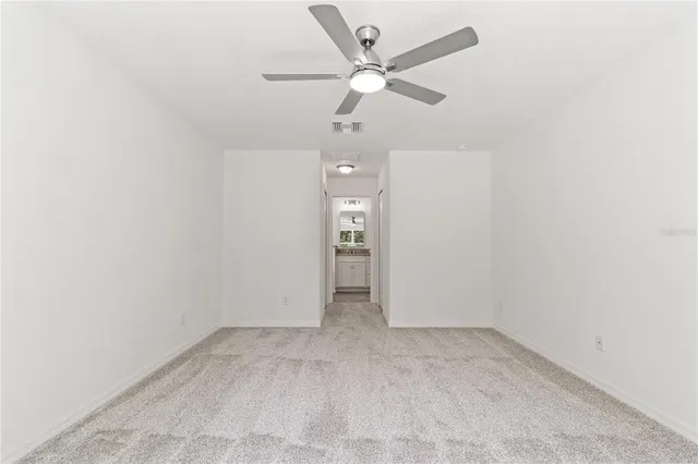 an empty room with fan and a ceiling fan