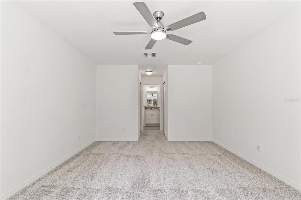 15333 Honeycreeper Road Brooksville, FL 34614 - Photo 8 of 19 an empty room with fan and a ceiling fan