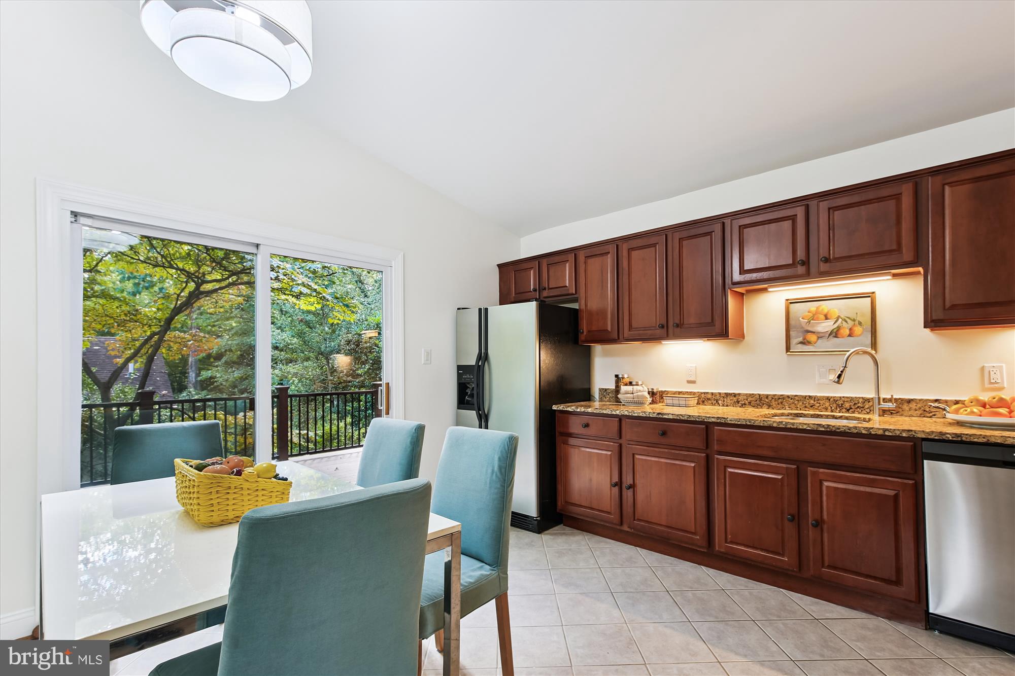 11221 South Shore Road Reston, VA 20190 - Photo 16 of 61 a kitchen with granite countertop a stove a sink dishwasher a dining table and chair with wooden floor