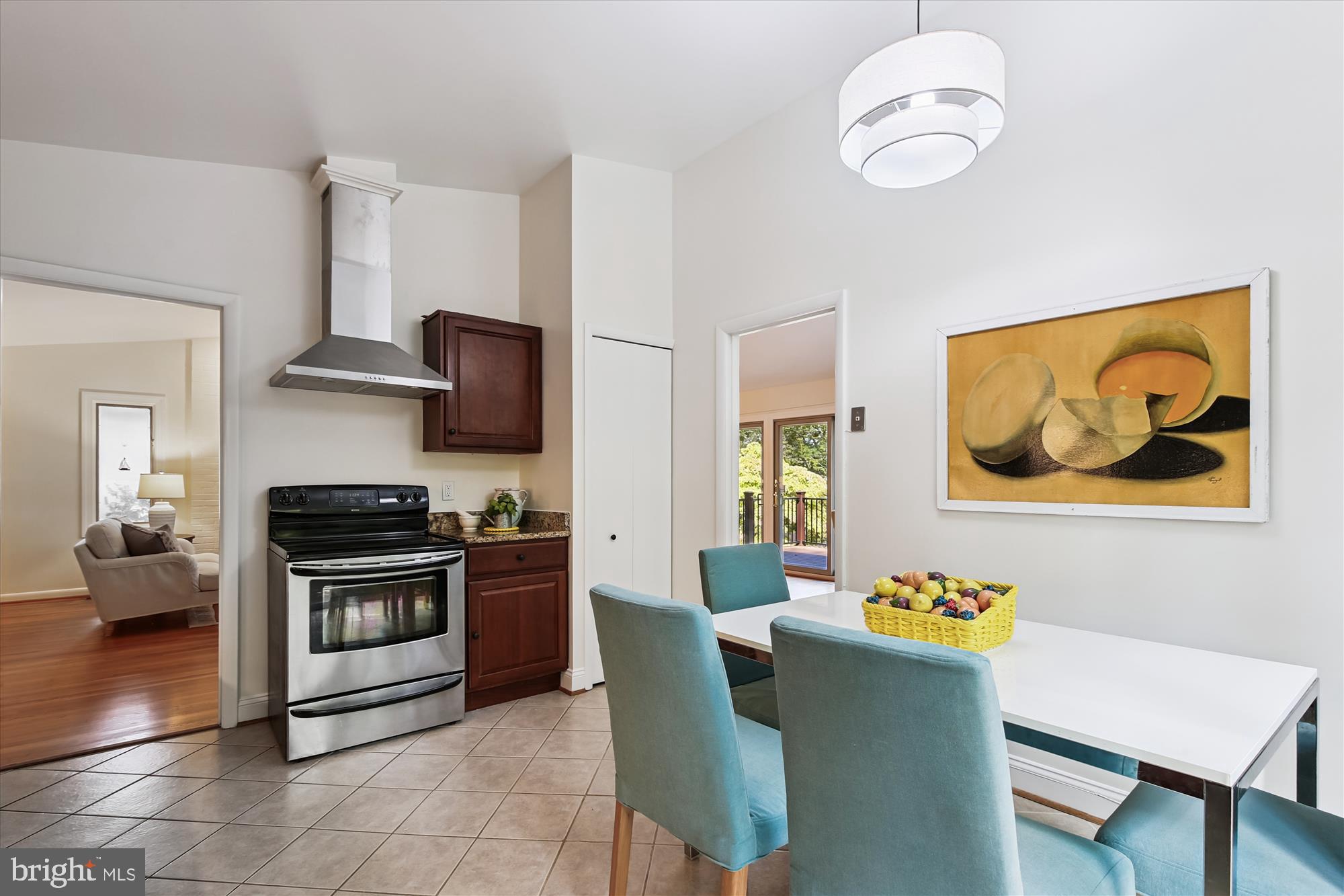 11221 South Shore Road Reston, VA 20190 - Photo 18 of 61 a kitchen with stainless steel appliances a stove a sink dishwasher a microwave oven and a dining table with wooden cabinet