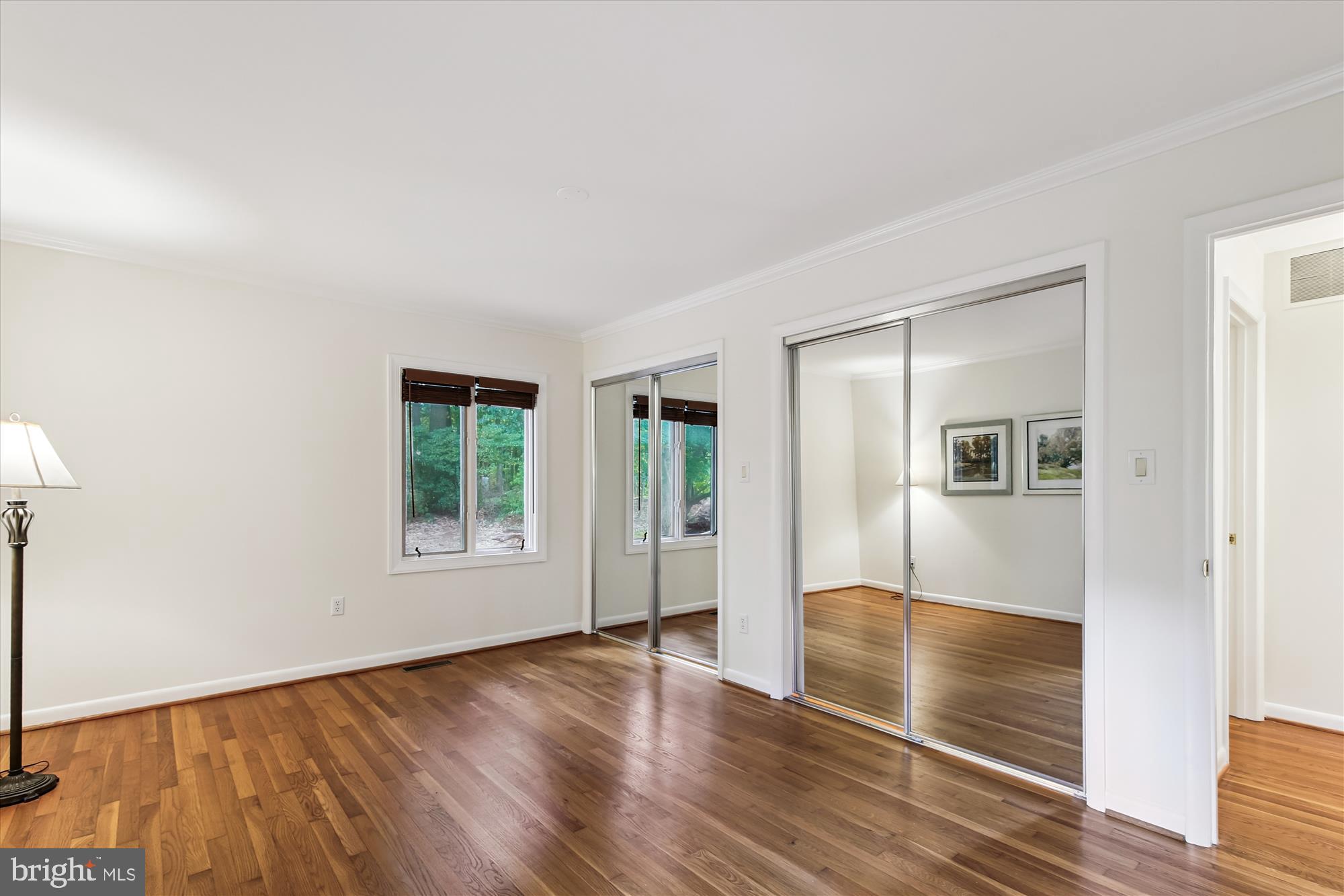 11221 South Shore Road Reston, VA 20190 - Photo 27 of 61 an empty room with wooden floor and windows