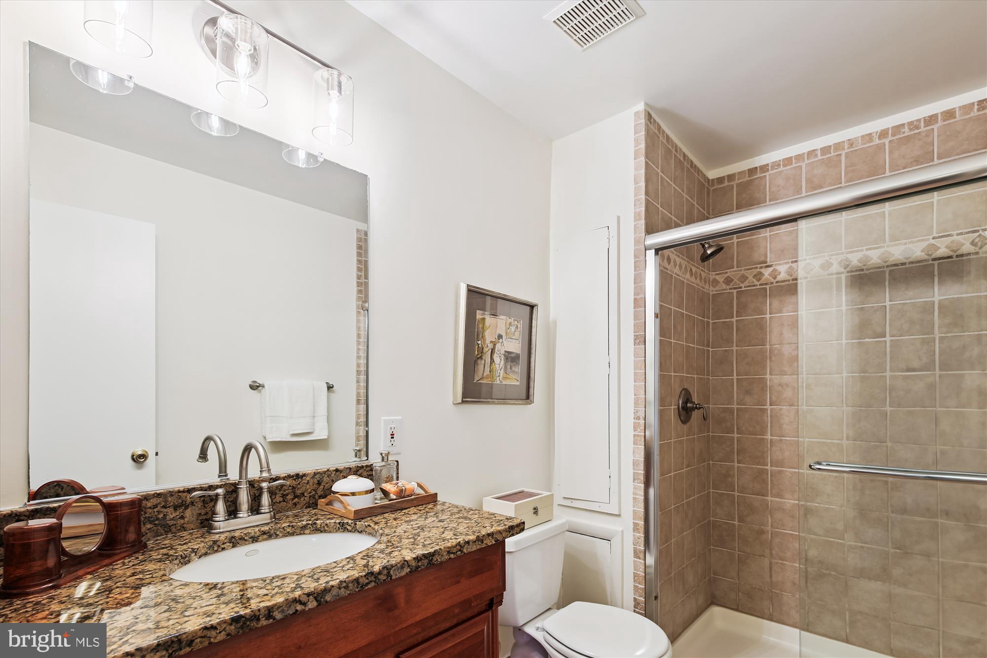 11221 South Shore Road Reston, VA 20190 - Photo 29 of 61 a bathroom with a granite countertop sink and a mirror