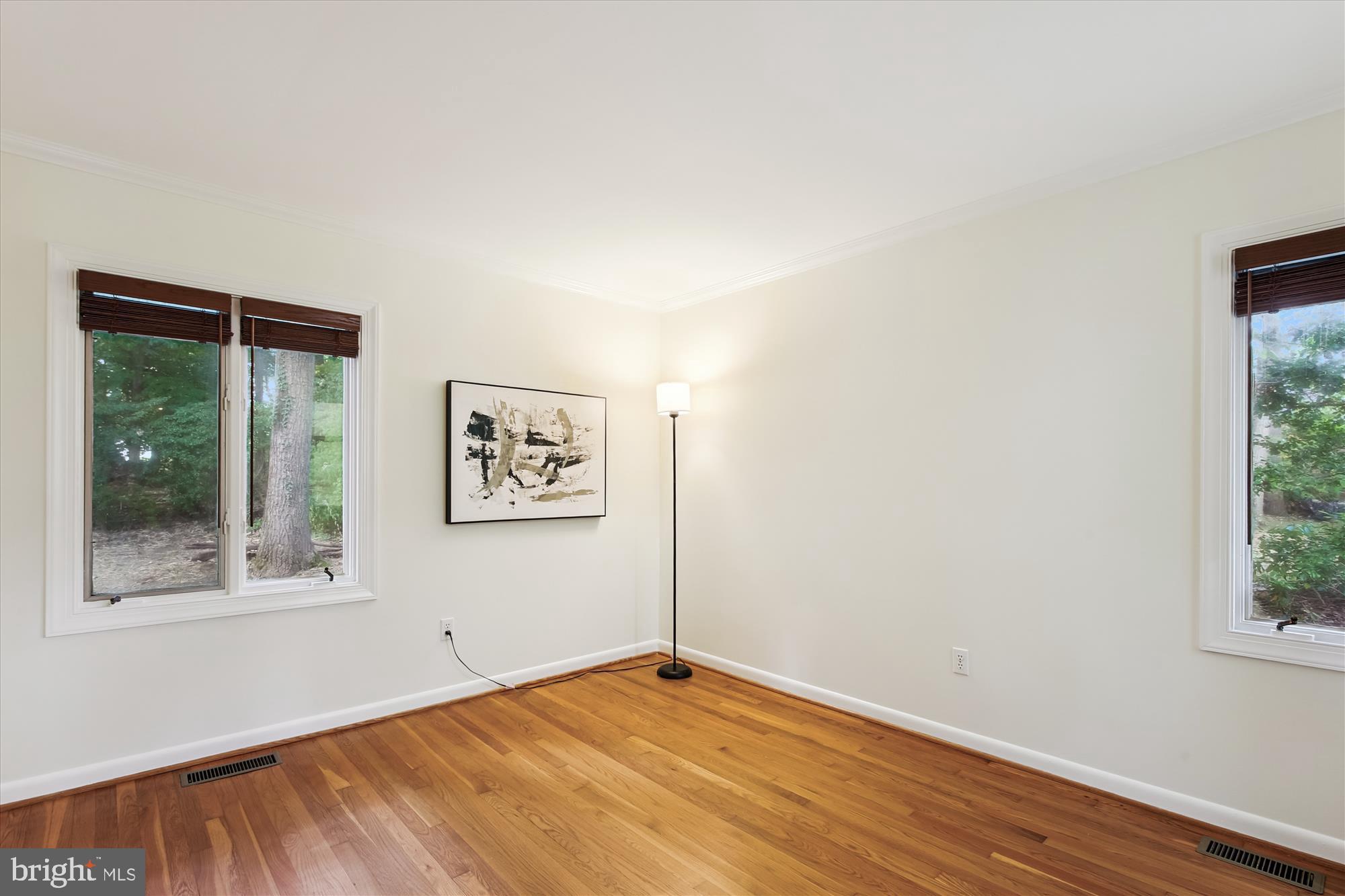 11221 South Shore Road Reston, VA 20190 - Photo 30 of 61 an empty room with wooden floor and windows