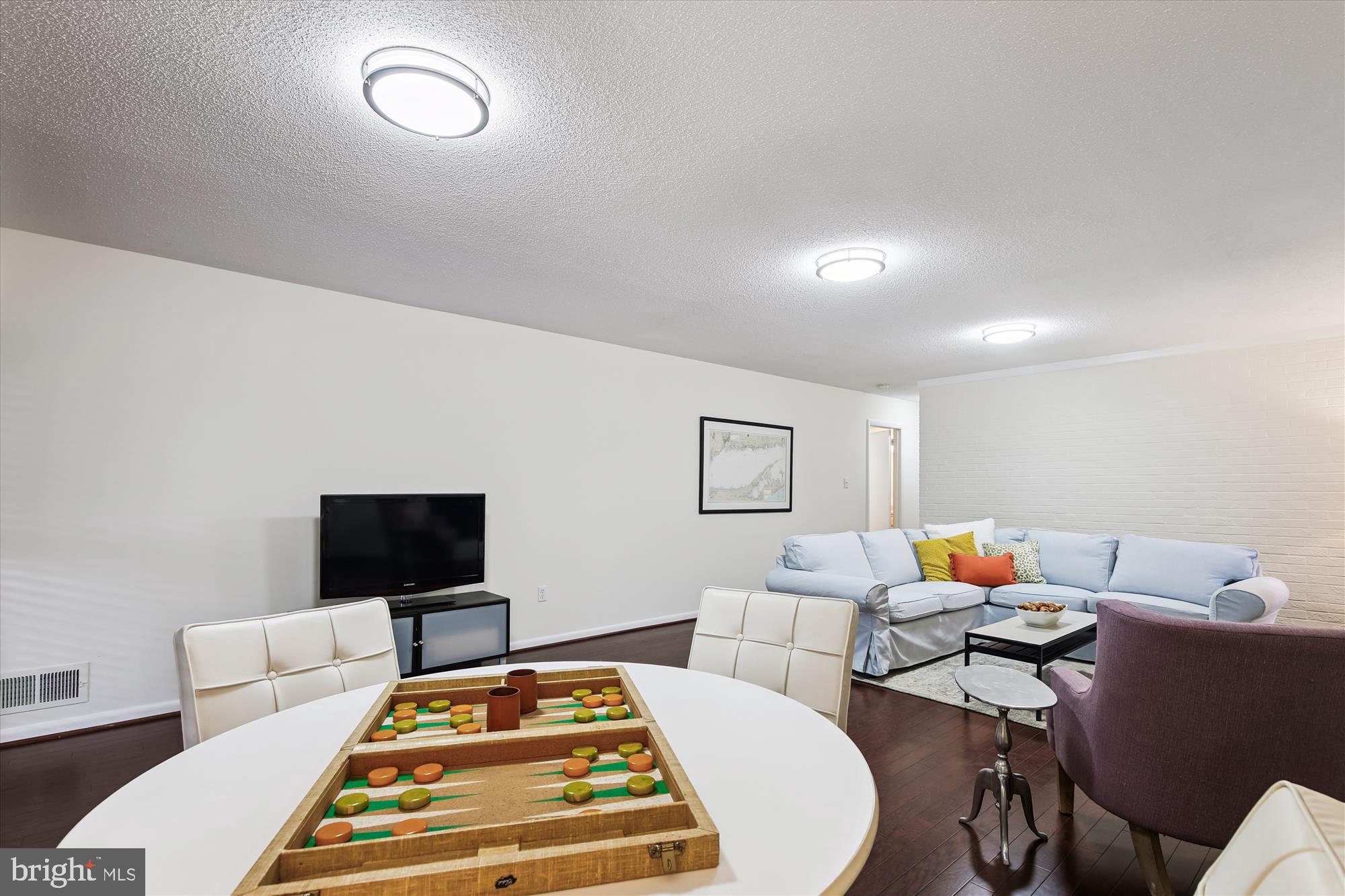 11221 South Shore Road Reston, VA 20190 - Photo 50 of 61 a living room with furniture and a flat screen tv