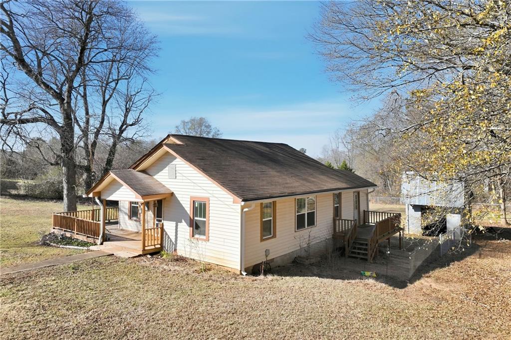 a front view of a house with a yard covered in snow