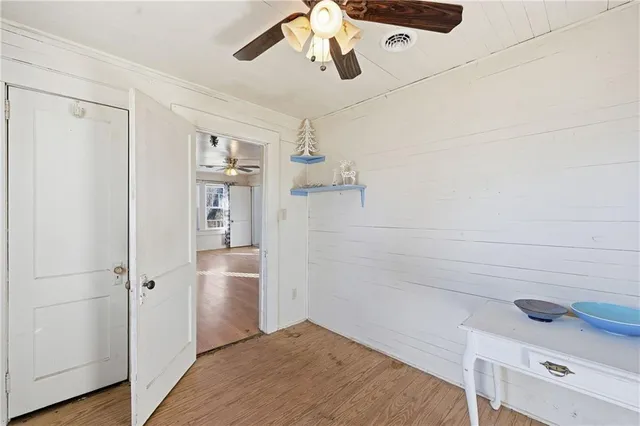 a view of empty room with wooden floor