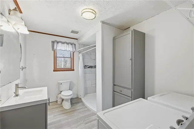 a bathroom with a toilet sink and a mirror