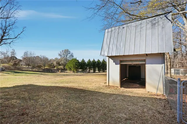 a view of a house with a yard and roof