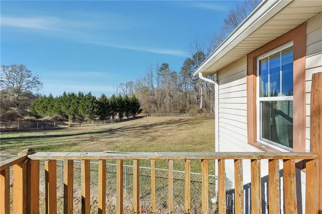 a view of a wooden deck and a yard