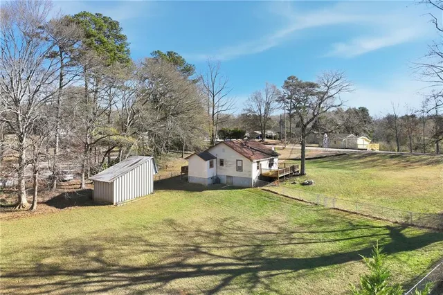 a view of a house with yard and sitting area