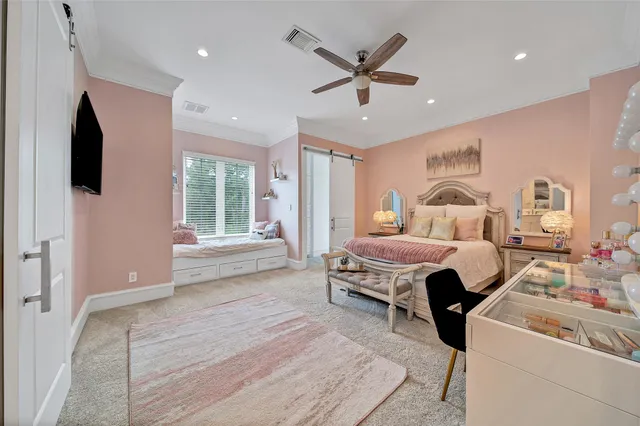 a bedroom with a bed and a large window