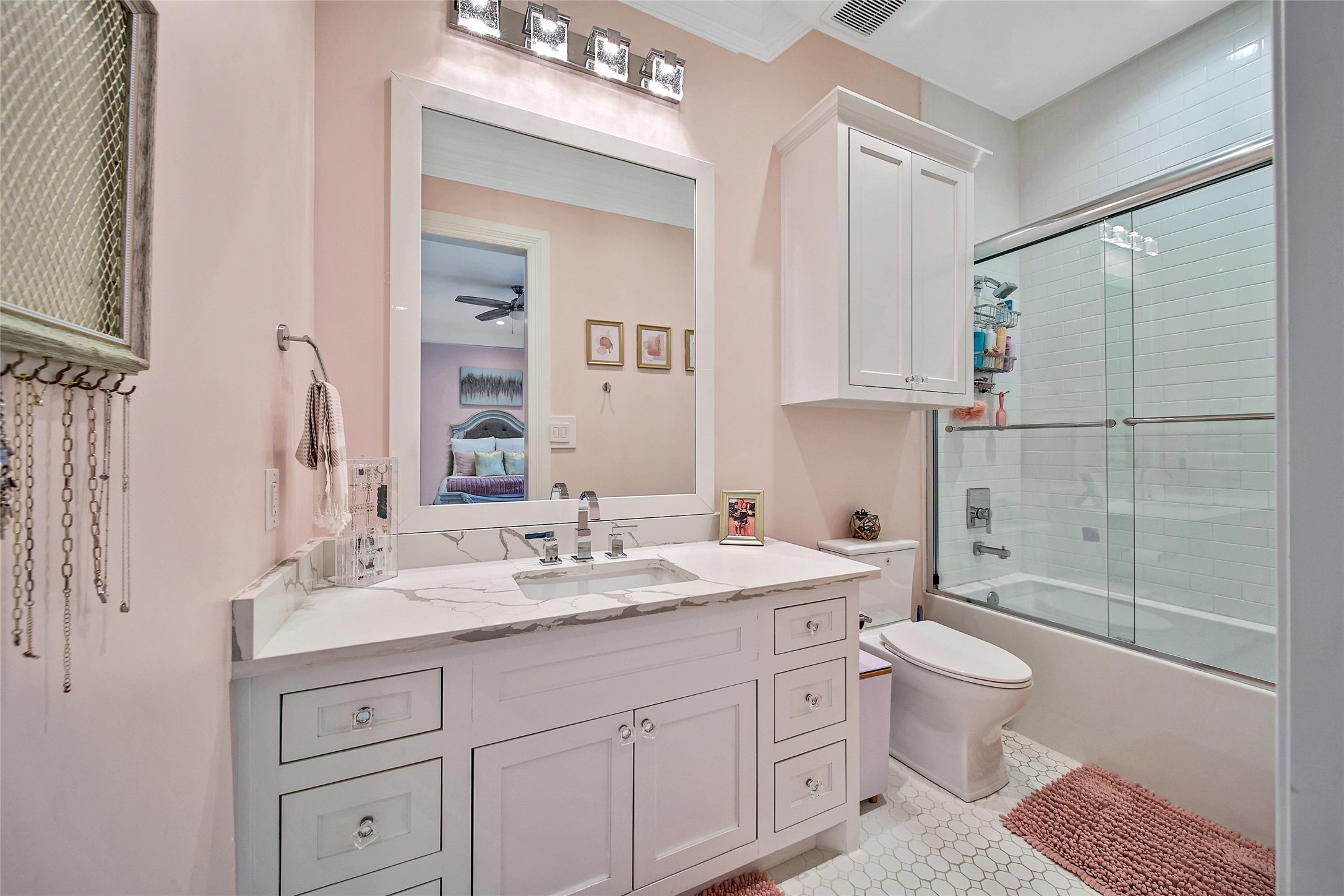 24357 East Webb Road Porter, TX 77365 - Photo 24 of 50 a bathroom with a sink a toilet and a mirror