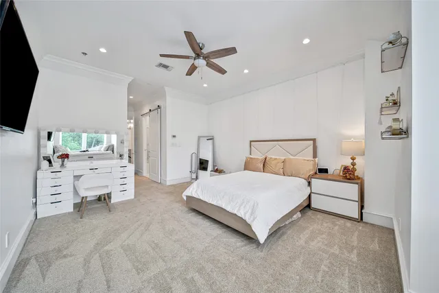 a spacious bedroom with a bed and a chandelier