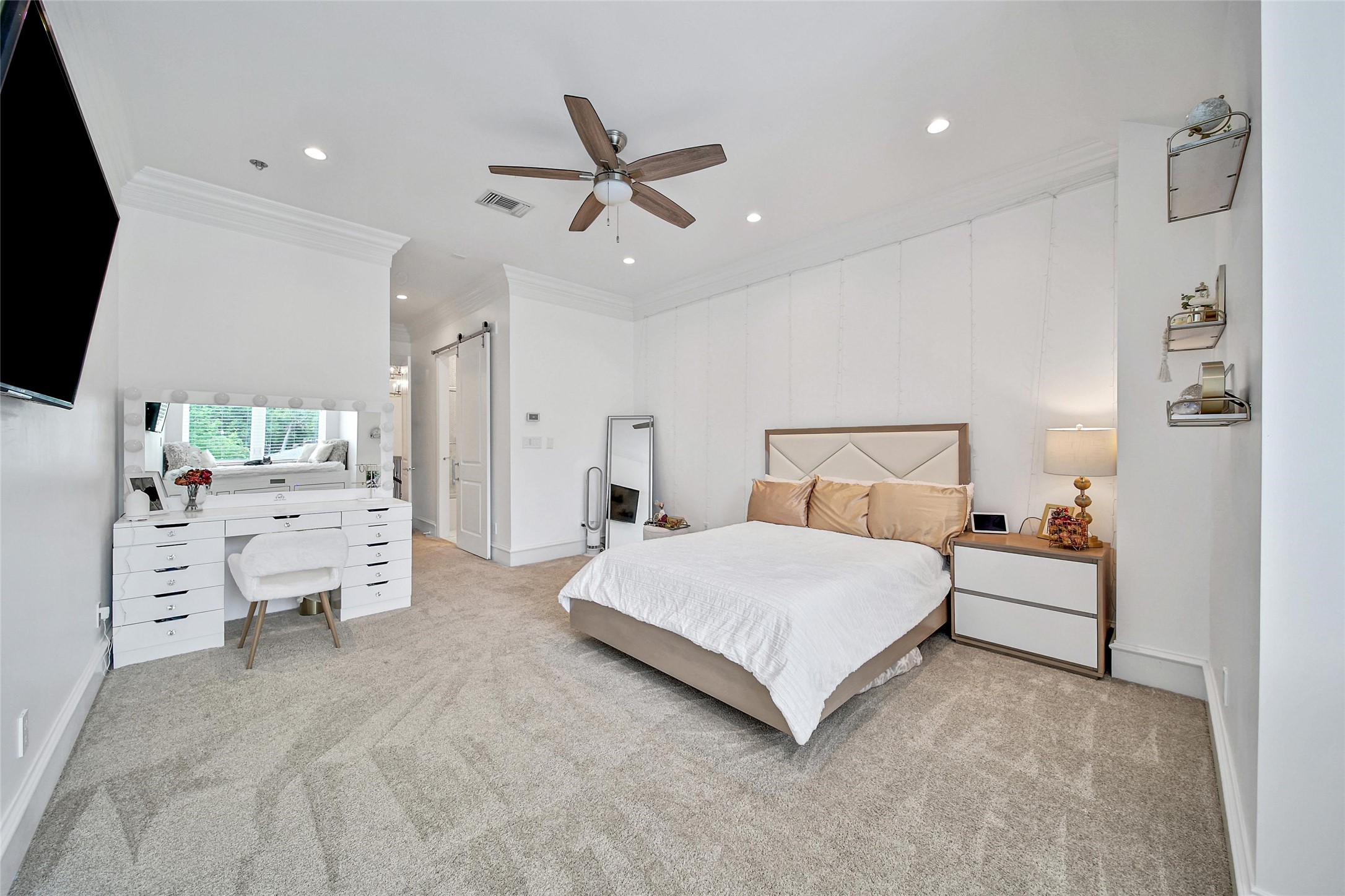 24357 East Webb Road Porter, TX 77365 - Photo 29 of 50 a spacious bedroom with a bed and a chandelier