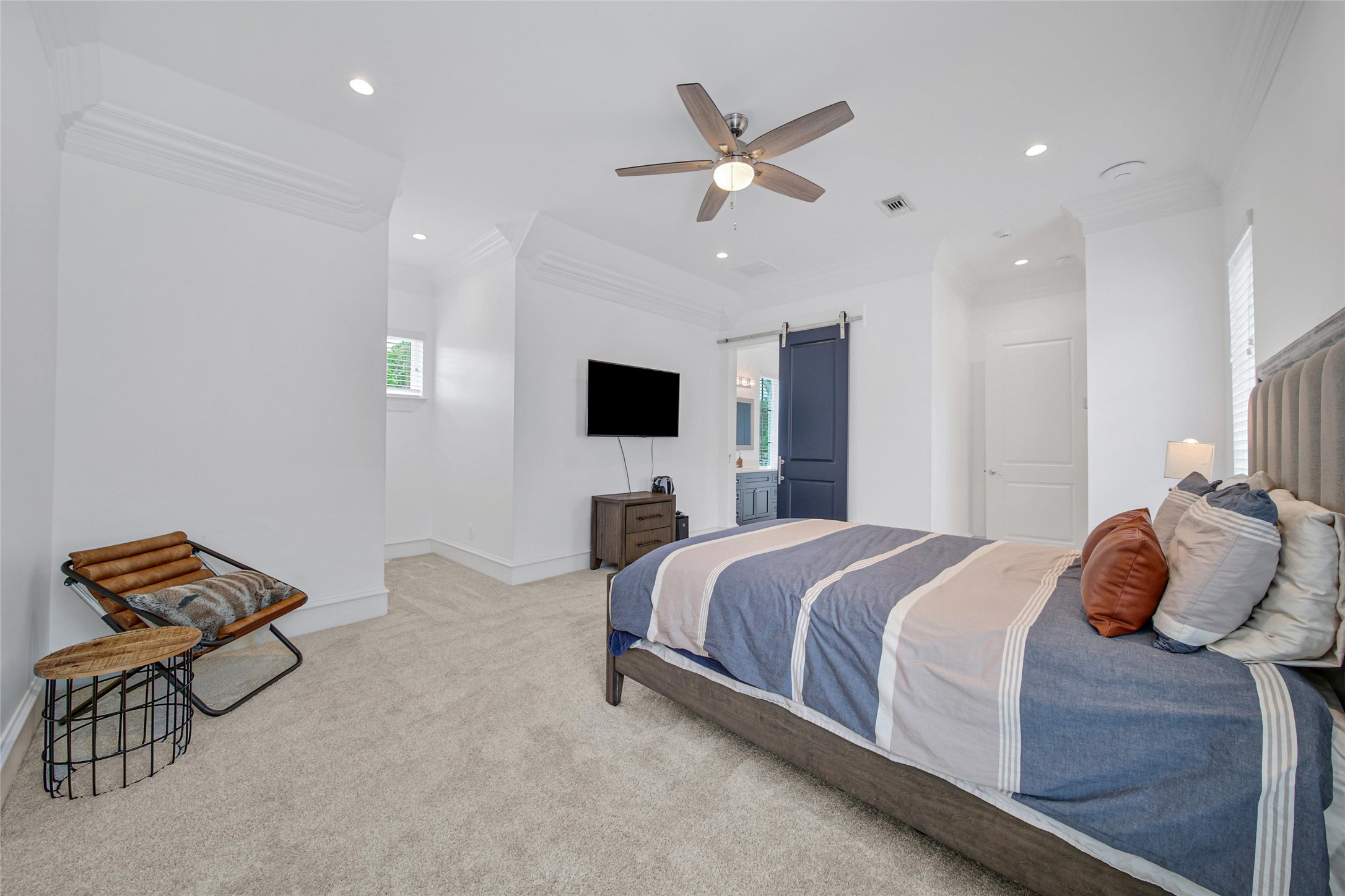 24357 East Webb Road Porter, TX 77365 - Photo 31 of 50 a bedroom with a bed and a chandelier