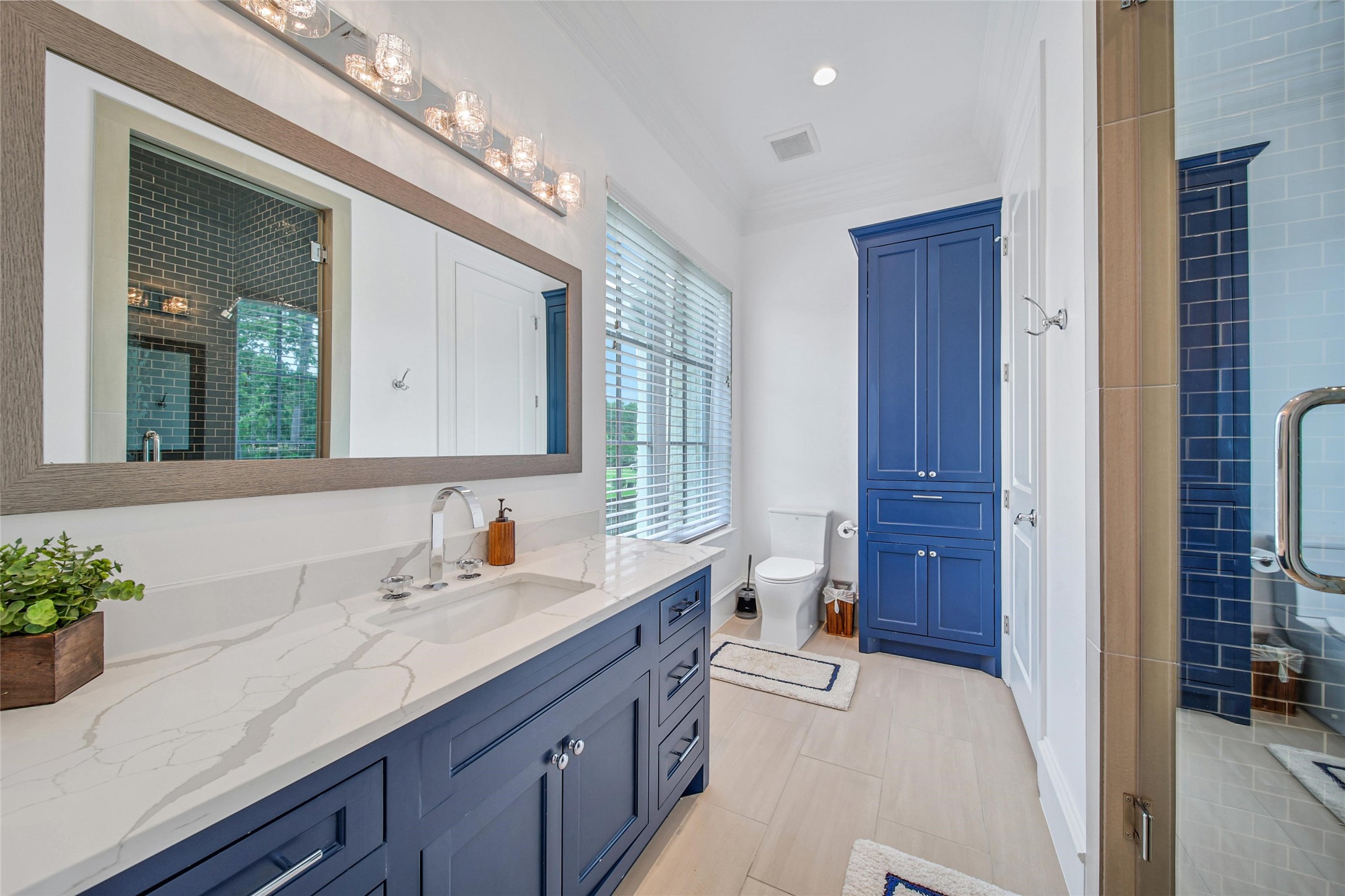 24357 East Webb Road Porter, TX 77365 - Photo 33 of 50 a spacious bathroom with a granite countertop sink a mirror and a shower
