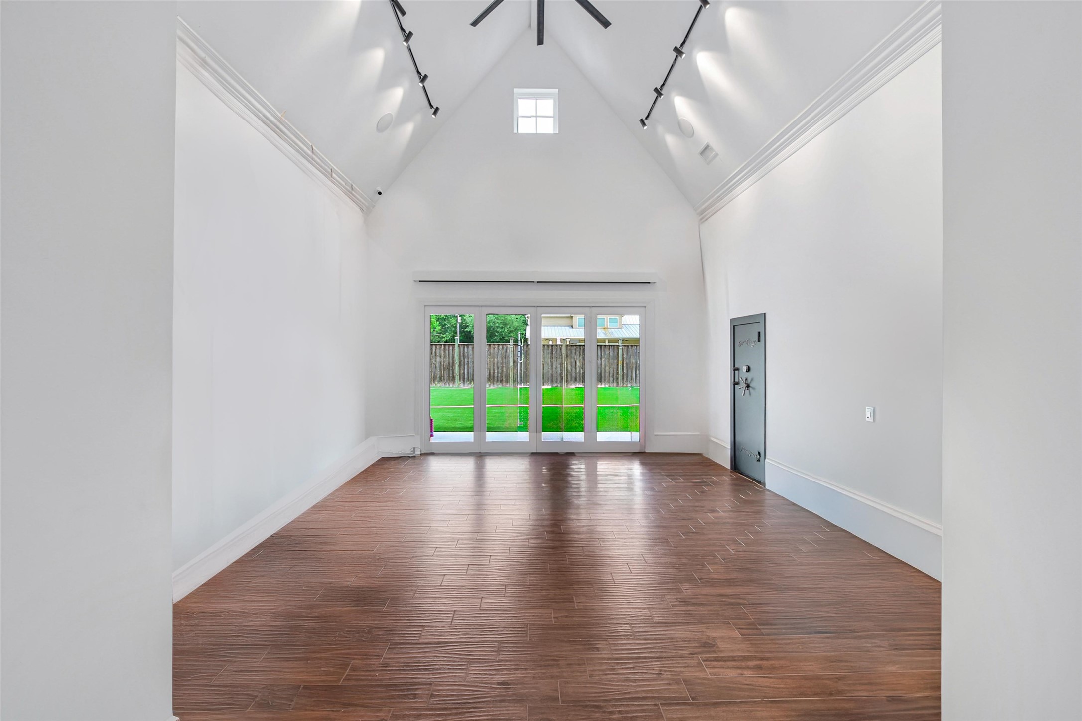 24357 East Webb Road Porter, TX 77365 - Photo 39 of 50 a view of an empty room with wooden floor and fan