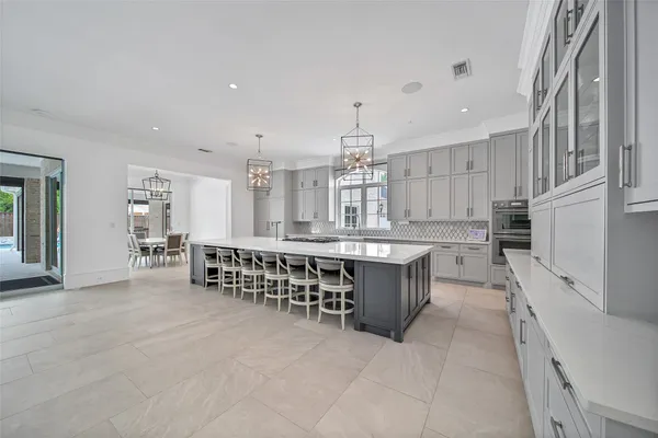 a large white kitchen with a large window