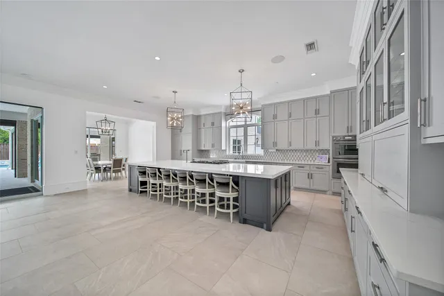 a large white kitchen with a large window