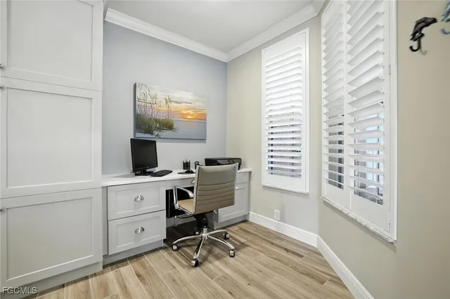 a view of a workspace with furniture and a window