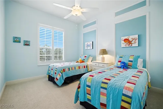 a bedroom with two beds and a window