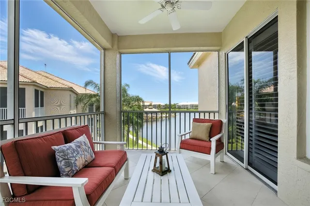 a balcony with couple of chairs and a couch