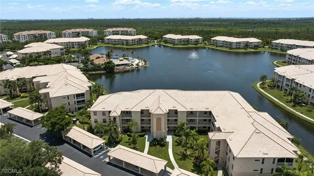 an aerial view of a house with a lake view