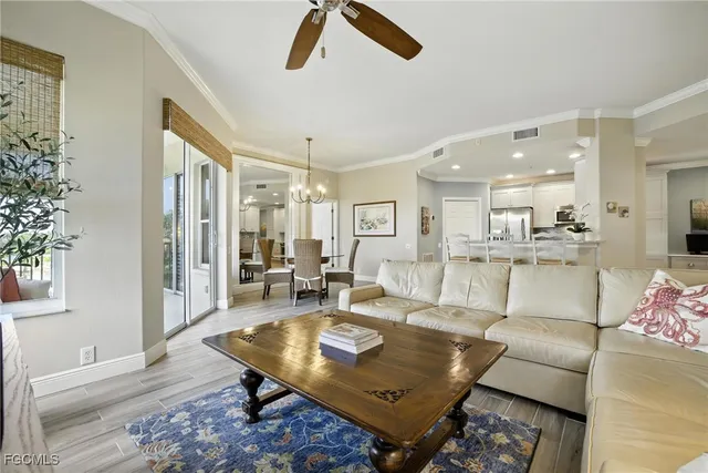a living room with furniture and kitchen view