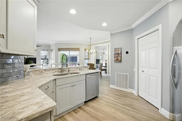 a kitchen with a sink stove and cabinets