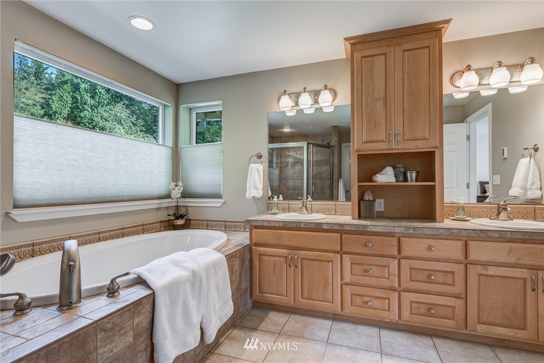 2633 189th Street Southeast Bothell, WA 98012 - Photo 26 of 35 a spacious bathroom with a granite countertop sink mirror and bathtub