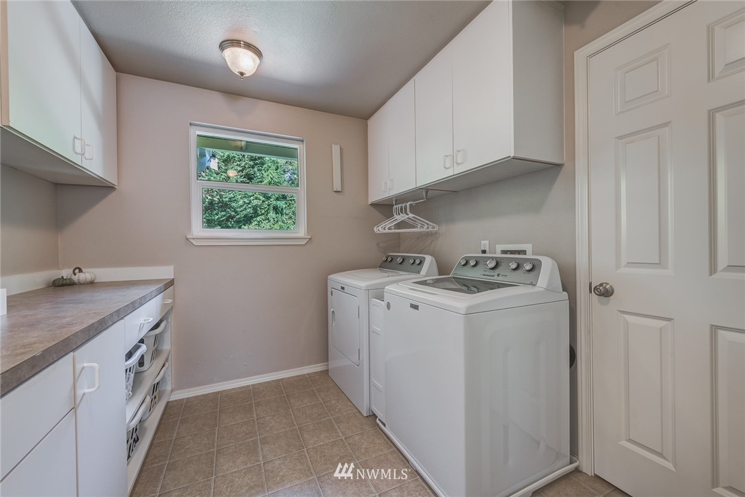 2633 189th Street Southeast Bothell, WA 98012 - Photo 32 of 35 a utility room with cabinets washer and dryer