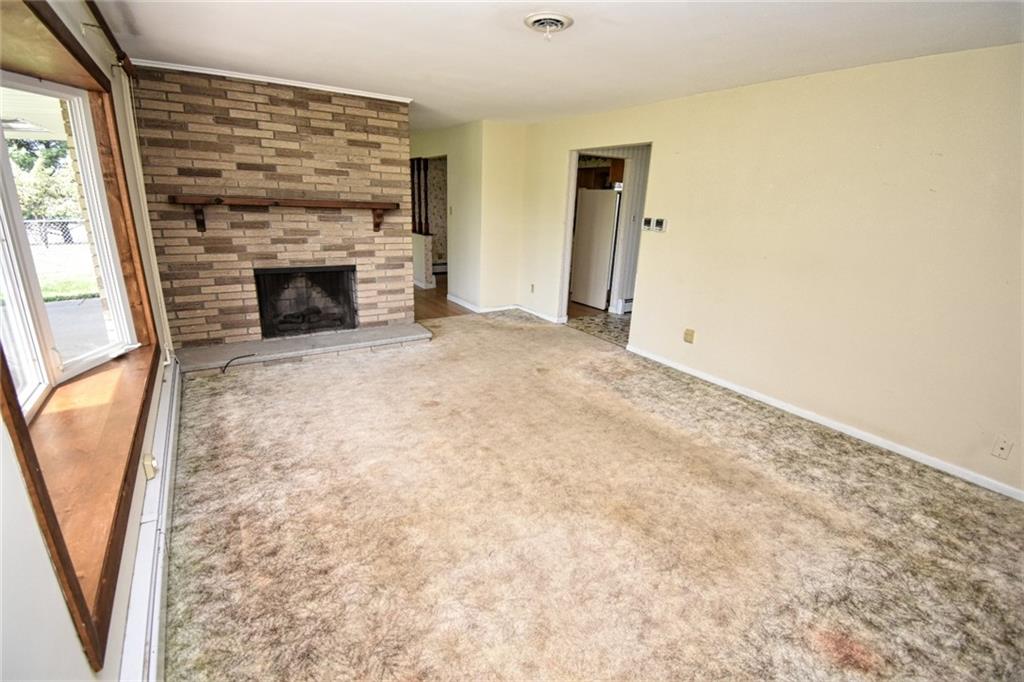 206 Hamtom Road Eighty Four, PA 15330 - Photo 3 of 21 a view of empty room with fireplace and wooden floor