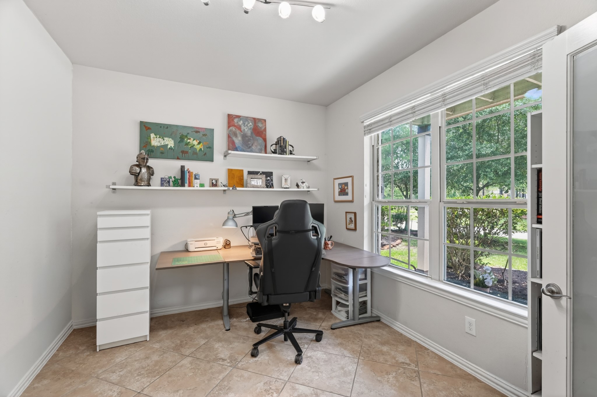 79 West Jagged Ridge Circle Spring, TX 77389 - Photo 8 of 50
This dedicated home office features a built-in desk and large windows overlooking the tree-lined backyard, creating a bright and productive workspace. Whether you work from home full-time or just need a quiet spot to manage household tasks, this room delivers.