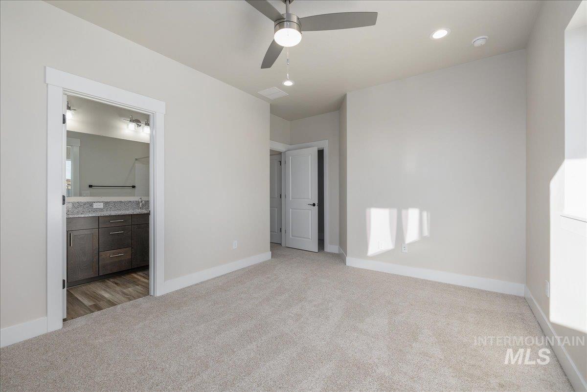 1408 North Cole Road Boise, ID 83704 - Photo 19 of 32 Plush carpeting, recessed lighting, ceiling fan, and white trim