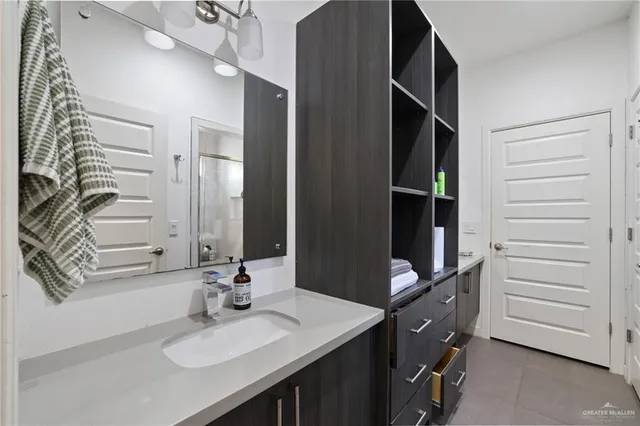 a bathroom with a sink vanity and a mirror