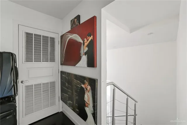 a view of staircase with railing and white walls