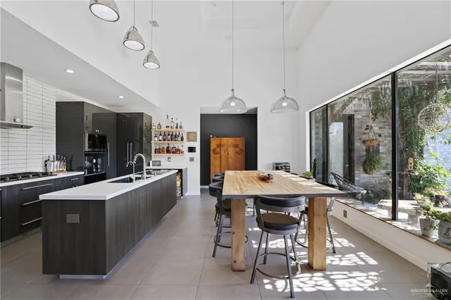 a large kitchen with a table and chairs