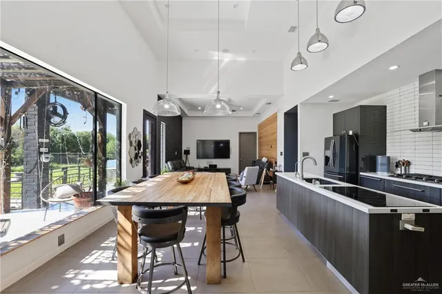 a large kitchen with a table and chairs